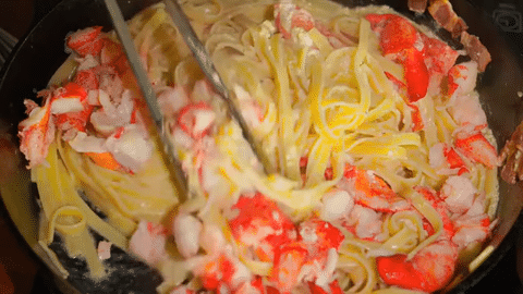 Lobster Carbonara in a pan, being stirred